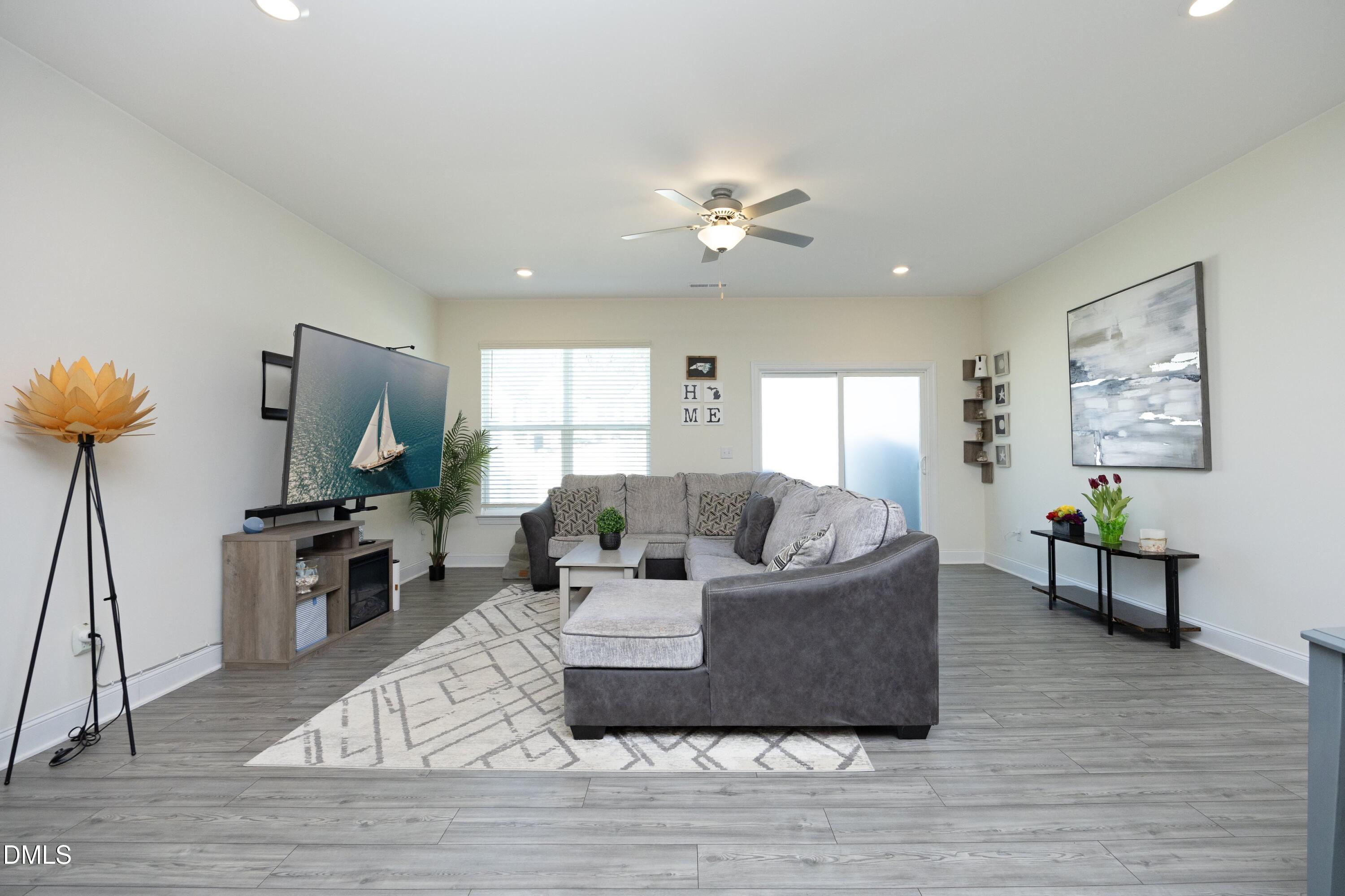 1002 Heartstone Way Durham, NC 27713 - Photo 10 of 35 a living room with furniture and a flat screen tv