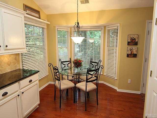 8705 Walkelin Court Raleigh, NC 27615 - Photo 7 of 12 The breakfast area is part of the lovely kitchen and has a bay window for lots of light as you drink your morning coffee.