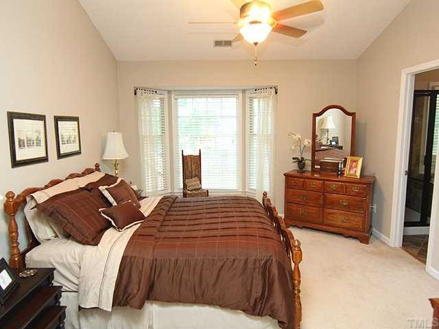 8705 Walkelin Court Raleigh, NC 27615 - Photo 8 of 12 The master bedroom has vaulted ceilings, a ceiling fan, walk in closet and large bay window.