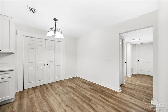 a view of a room with wooden floor