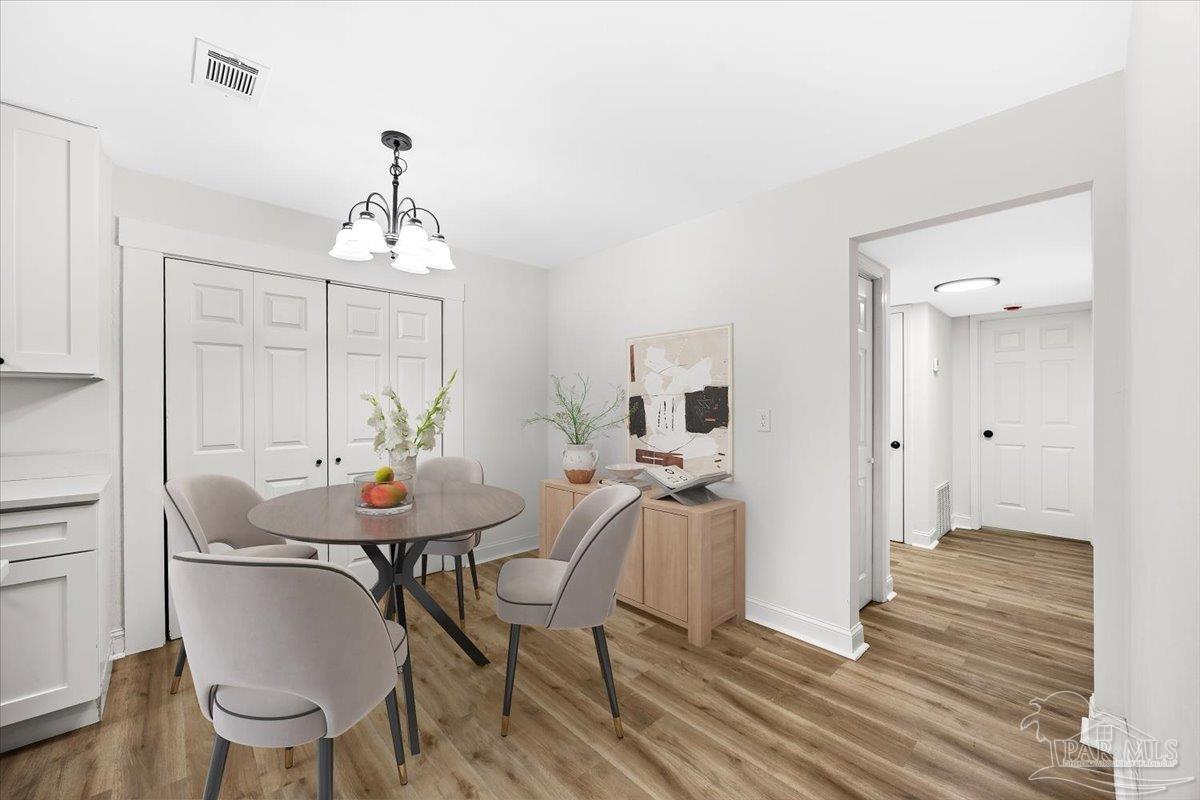 5149 Crestwood Road Pensacola, FL 32503 - Photo 14 of 53 a view of a dining room with furniture and wooden floor