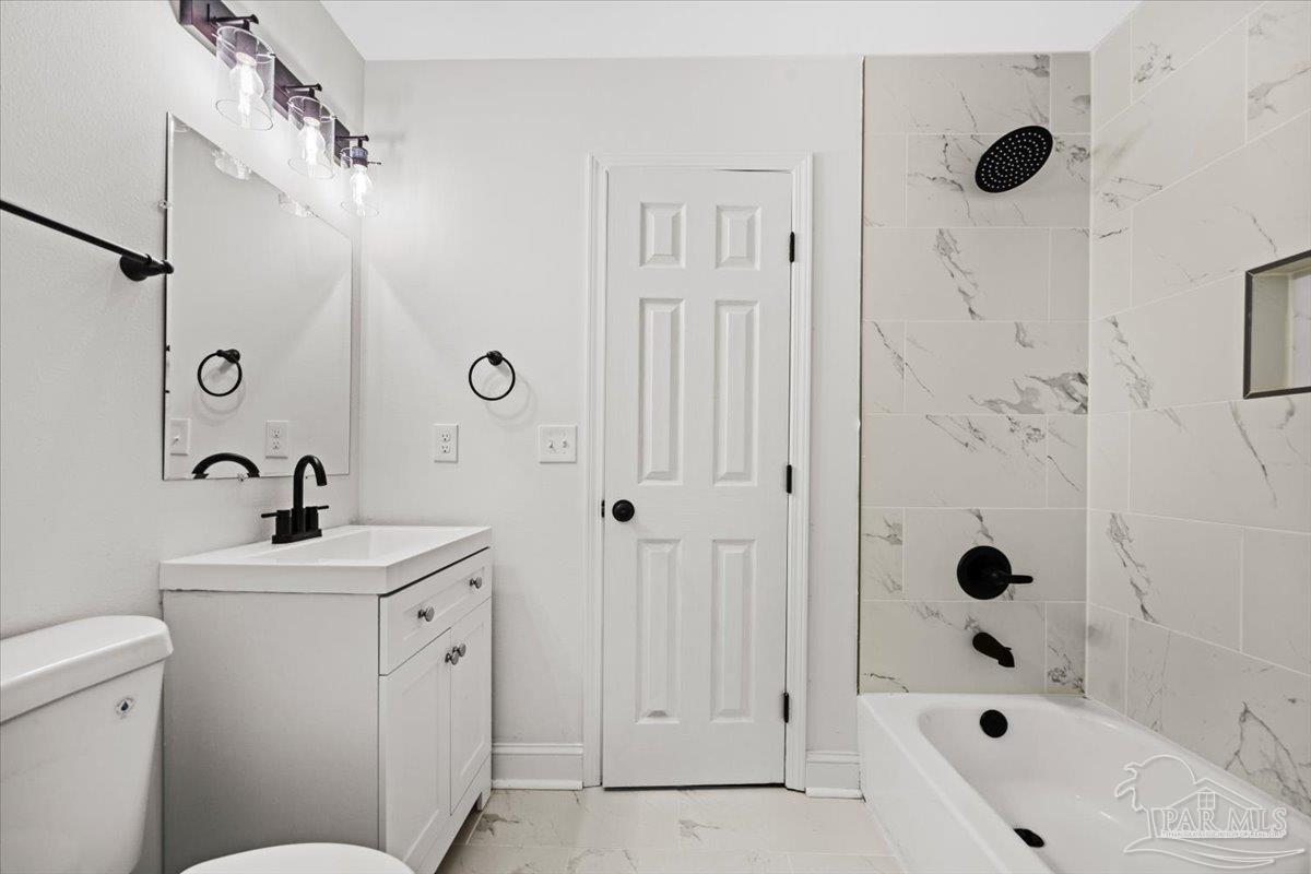 5149 Crestwood Road Pensacola, FL 32503 - Photo 18 of 53 a bathroom with a sink a toilet and shower