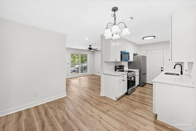 a kitchen with a sink and a stove top oven