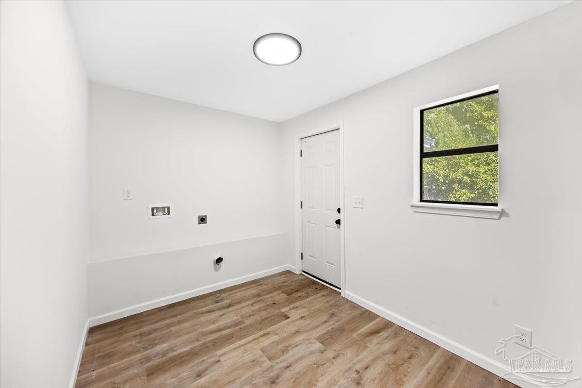 5149 Crestwood Road Pensacola, FL 32503 - Photo 21 of 53 a view of a room with wooden floor and windows