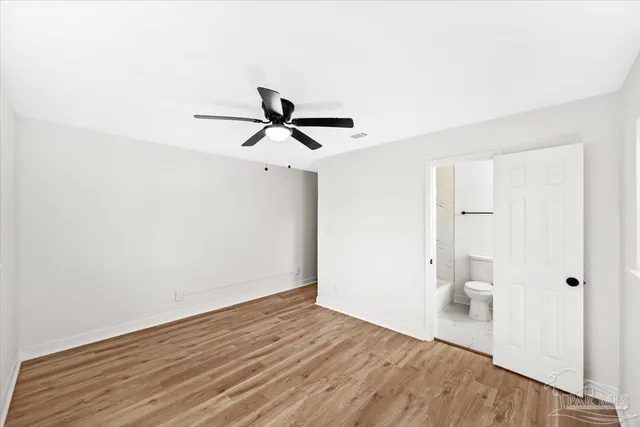 a view of a room with wooden floor and white walls