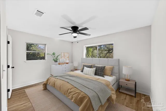 a bedroom with a large bed and a chandelier