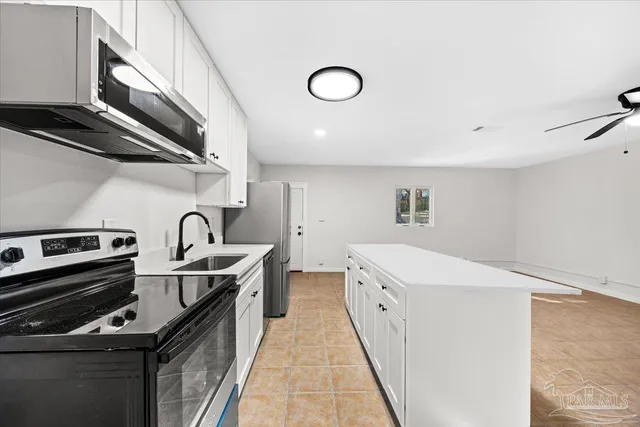 a kitchen that has a sink and a stove