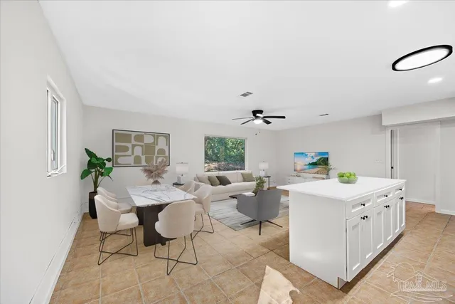 a living room with kitchen island furniture and a window