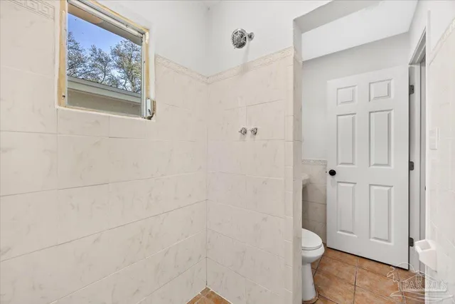 a bathroom with a toilet and a shower