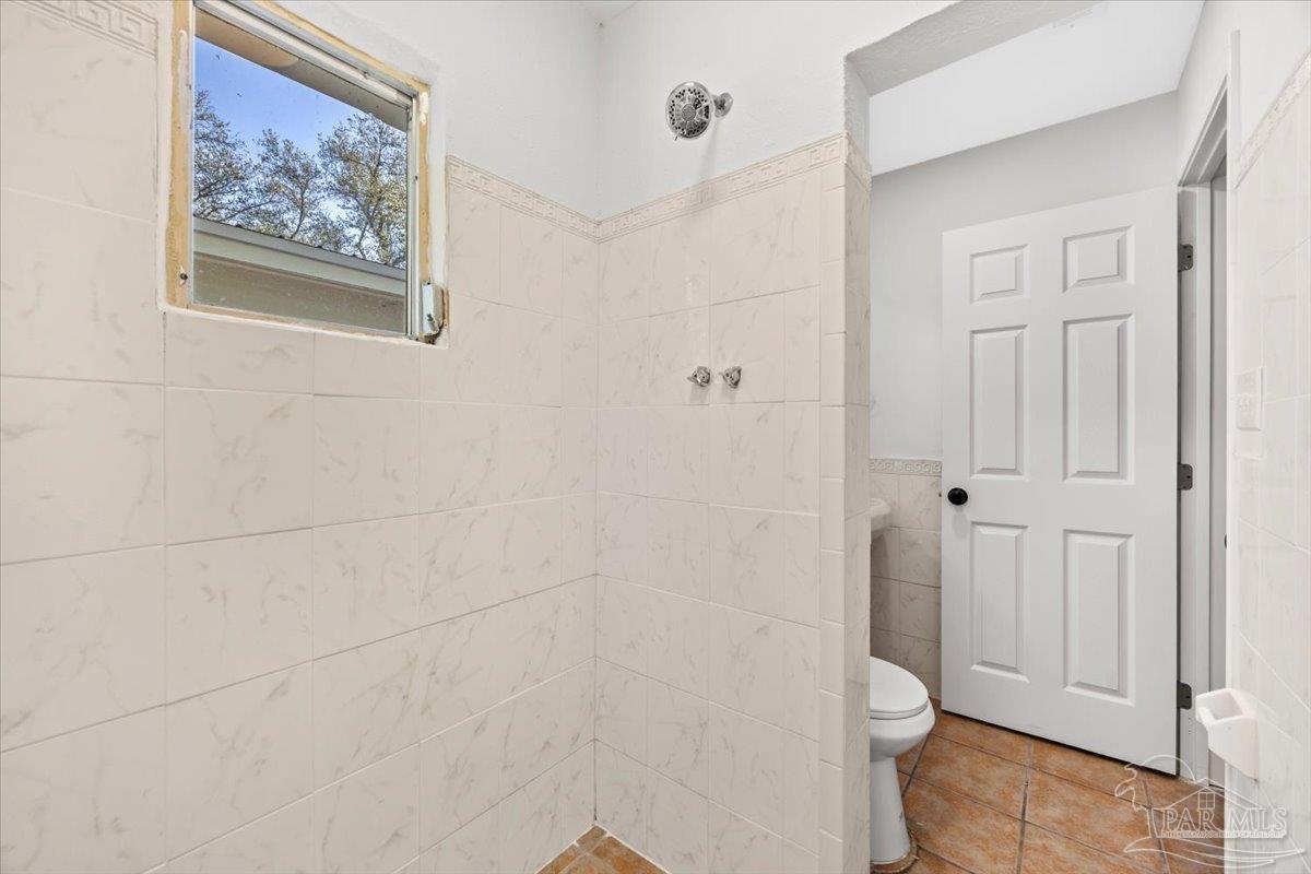 5149 Crestwood Road Pensacola, FL 32503 - Photo 40 of 53 a bathroom with a toilet and a shower