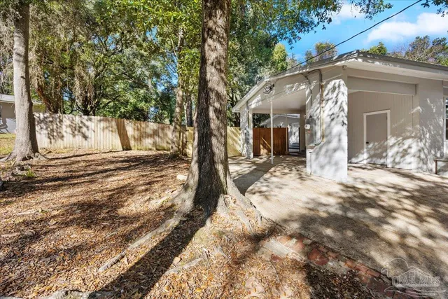 a view of a house with a yard covered in snow