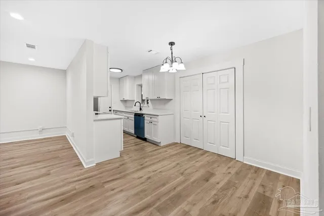 a view of a kitchen with wooden floor and a sink