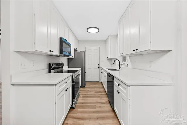 a kitchen with cabinets and a sink