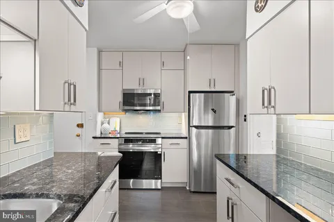 a kitchen with cabinets and window
