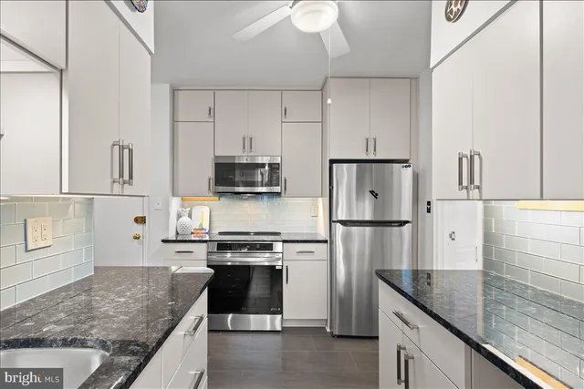 a kitchen with cabinets and window