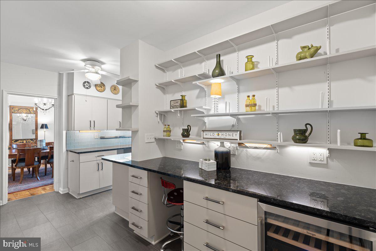 4301 Massachusetts Avenue Northwest, Unit A304 Washington, DC 20016 - Photo 15 of 38 Kitchen with built in desk and wine refrigerator
