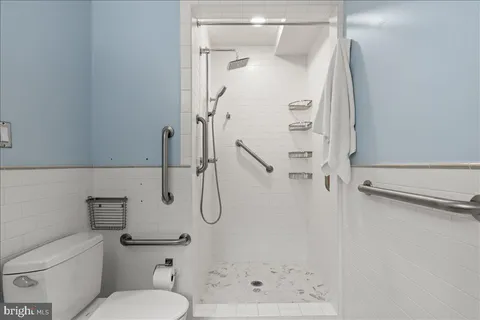 a living room with furniture and a book shelf