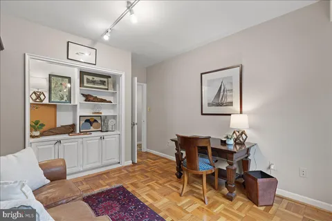 a living room with furniture and a book shelf