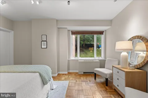 a bedroom with a bed and a lamp