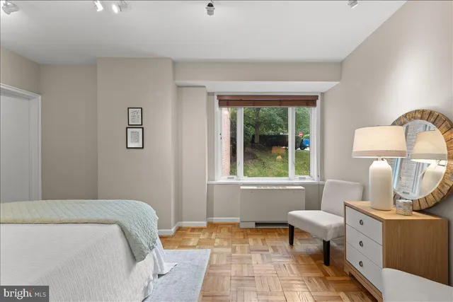 a bedroom with a bed and a lamp