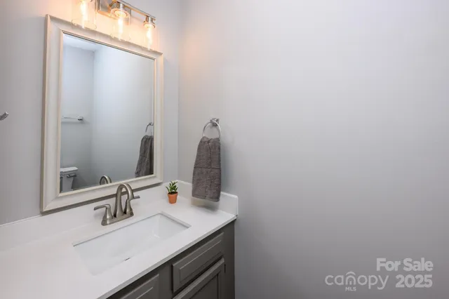 a bathroom with a sink vanity and a mirror