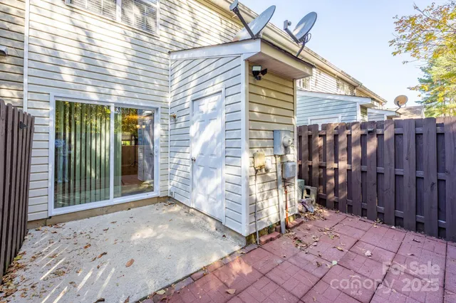 a view of a yard with plants and trees