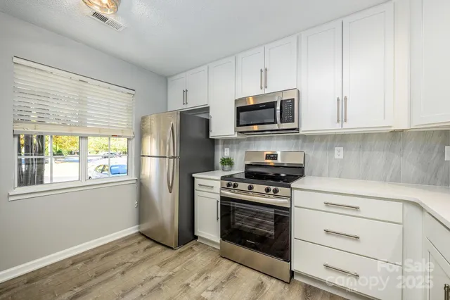 a kitchen with a refrigerator stove and microwave