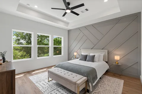 a bedroom with a large bed and a window