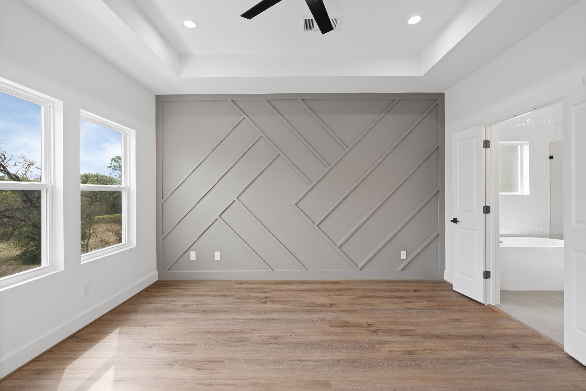 826 Curtin Street, Unit F Houston, TX 77018 - Photo 19 of 37 an empty room with wooden floor and windows