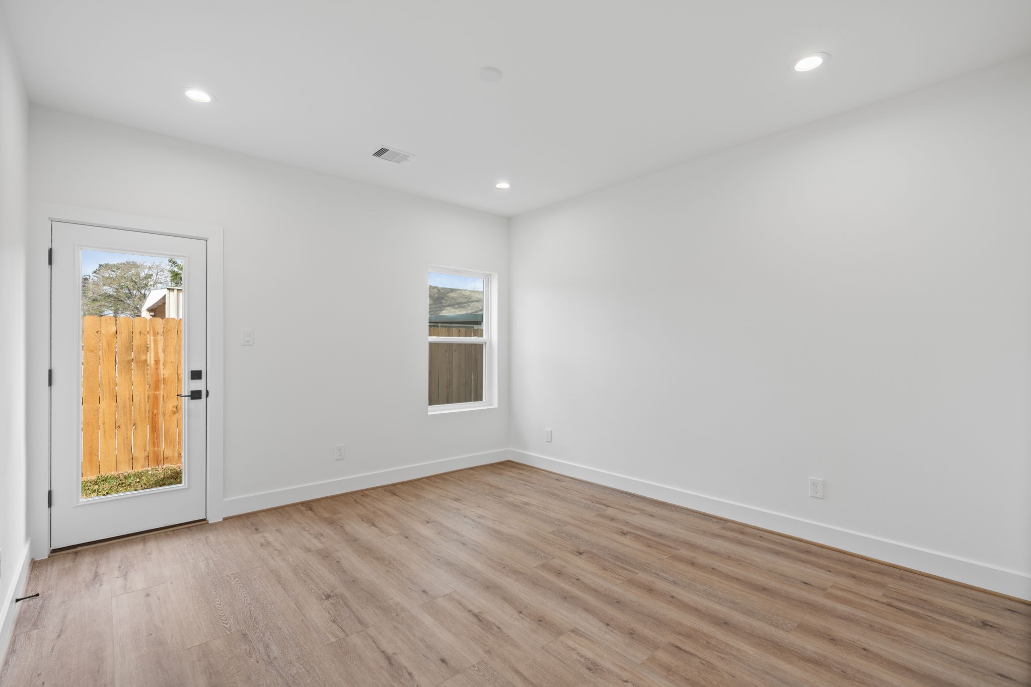 826 Curtin Street, Unit F Houston, TX 77018 - Photo 26 of 37 a view of empty room with wooden floor and fan