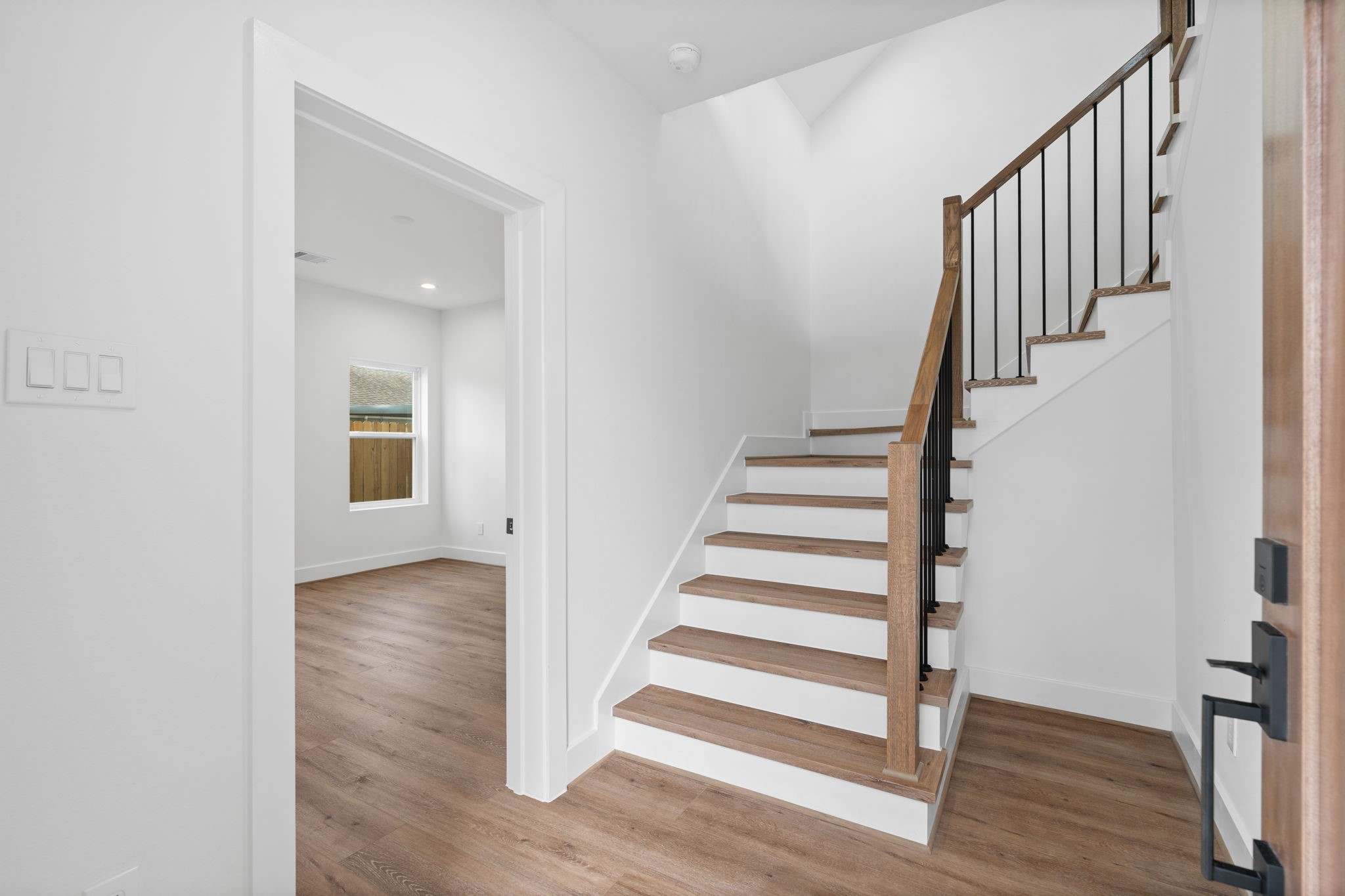 826 Curtin Street, Unit F Houston, TX 77018 - Photo 4 of 37 a view of staircase with wooden floor and white walls