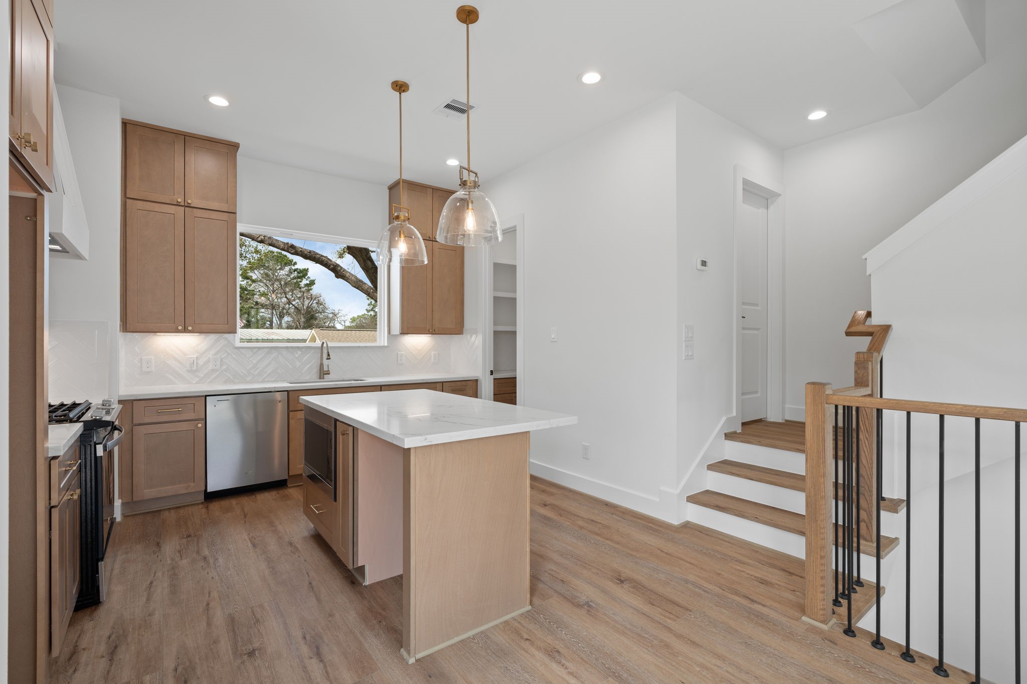 826 Curtin Street, Unit F Houston, TX 77018 - Photo 7 of 37 a kitchen with a sink appliances wooden floor and a window
