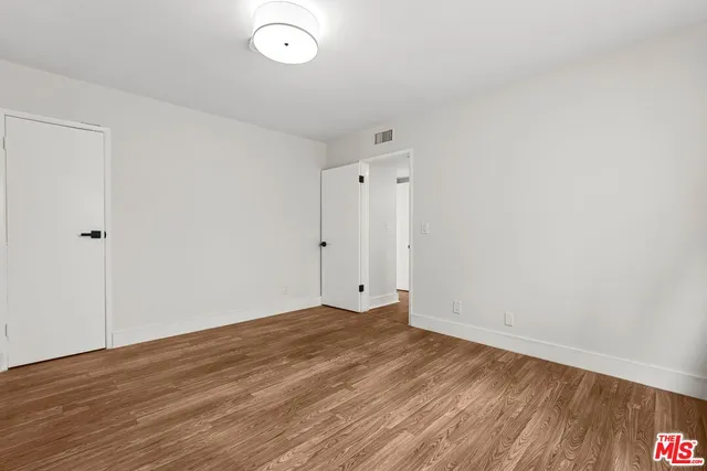 a view of room with wooden floor