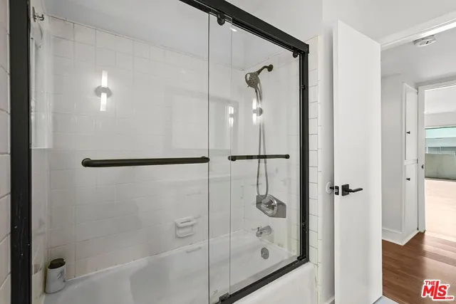 a bathroom with a glass shower door