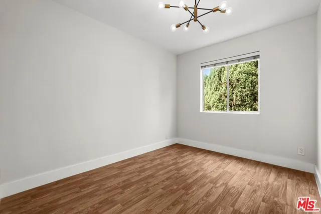 a view of a room with wooden floor and windows