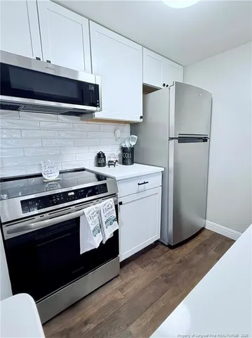 a kitchen with a stove microwave and refrigerator
