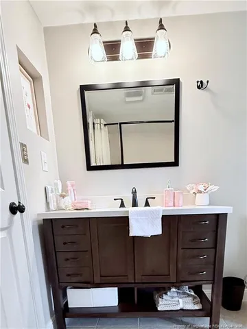 a bathroom with a sink vanity and mirror
