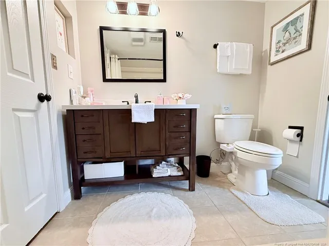 a bathroom with a sink toilet and mirror