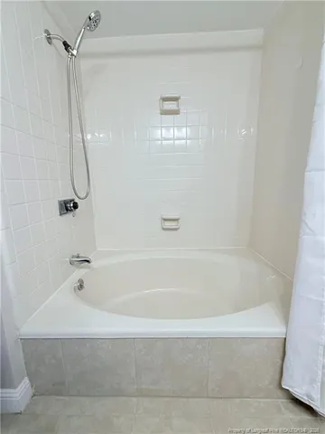 a bathroom with a shower and a bath tub