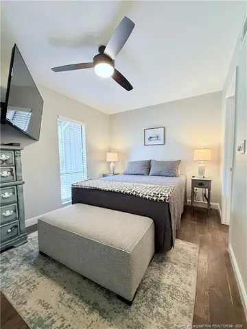 a bedroom with a large bed and a tv