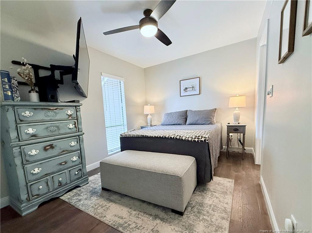 5 Pine Tree Road Pinehurst, NC 28374 - Photo 37 of 45 a bedroom with a bed and a chandelier