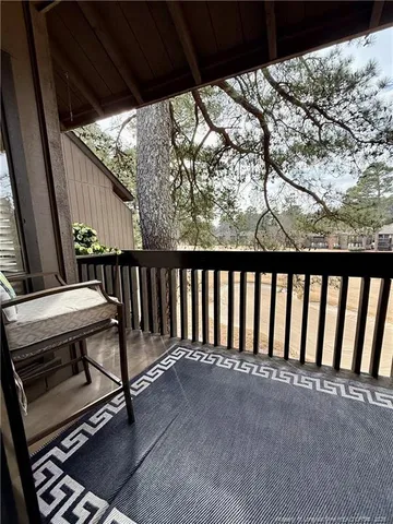 a view of a balcony with chair and table