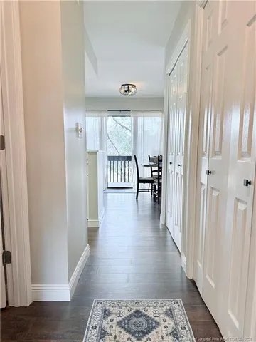 a view of a hallway with windows and stairs