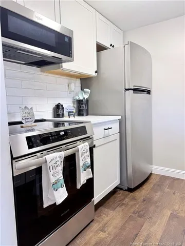 a kitchen with a stove and a refrigerator