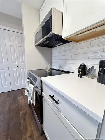 a kitchen with a stove and a microwave