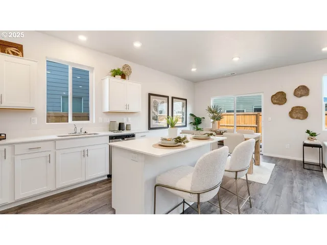 a kitchen with a sink a table and chairs