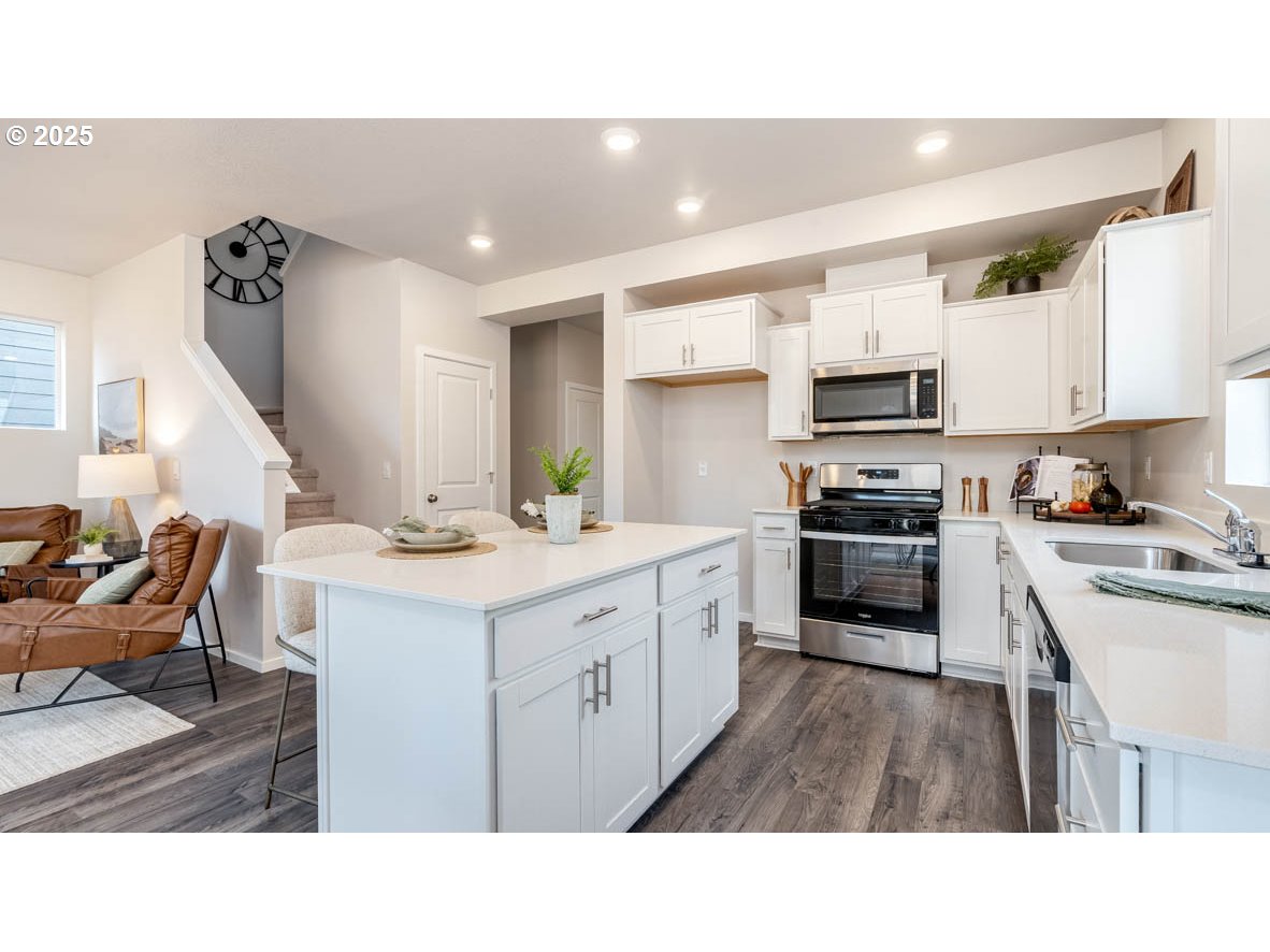 2805 U Street Springfield, OR 97477 - Photo 10 of 31 a kitchen with kitchen island a sink appliances and cabinets