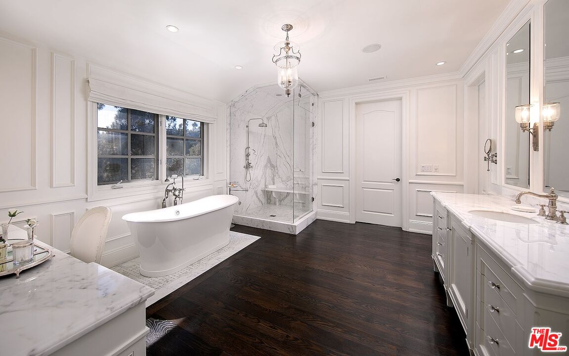 655 North Faring Road Los Angeles, CA 90077 - Photo 14 of 23 a bathroom with a granite countertop sink mirror and a bathtub