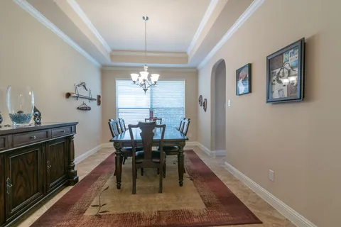 a view of a dining room with furniture and chandelier
