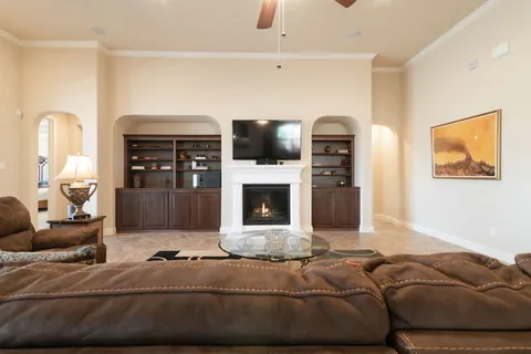 a living room with furniture a flat screen tv and a fireplace